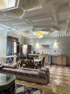 a living room with a table and a kitchen at Moroccan culture Apt! Airport in Marrakech