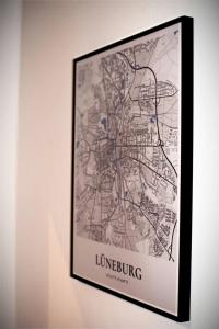 a framed picture of a map on a wall at Lüner Apartment in Lüneburg