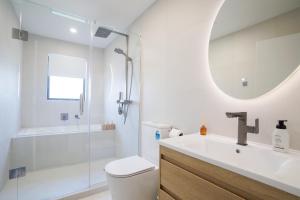a bathroom with a sink and a toilet and a shower at 4 bedrooms Retreat with Netflix with Prime Location in Auckland +50 photos