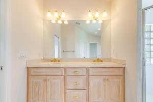 a bathroom with a sink and a large mirror at Half-Mi to Boat Ramp Canal-Front Florida Keys Gem in Tavernier +19 photos