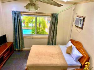 a bedroom with a bed and a window with a pool at Pundaquit Luxury Resort in San Antonio +116 photos