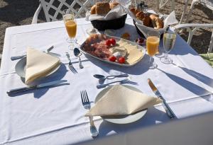 a table with a plate of food and a bowl of food at Schloss Hotel Colmdorf in Bayreuth