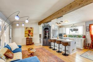 a kitchen and living room with a blue couch at 10 Mi to Red Rocks Denver Home with Fire Pit! in Denver