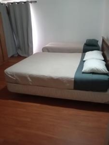a bed in a room with two mattresses at Refugio el Amparo de Paine in El Majuelo