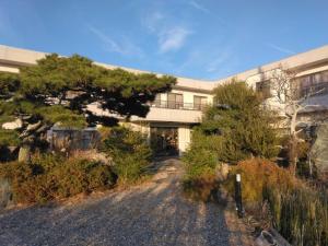 a building with a tree in front of it at Ogawaya Ryokan - Vacation STAY 16050v in Tahara