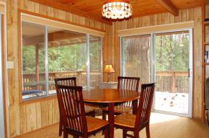 a dining room with a wooden table and chairs at Mountain Retreat in Wawona