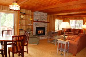 a living room with a couch and a fireplace at Mountain Retreat in Wawona