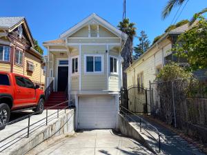 a red truck parked in front of a house at Victorian Retreat 2Bed, 1Bath, Parking, Game Room in Oakland