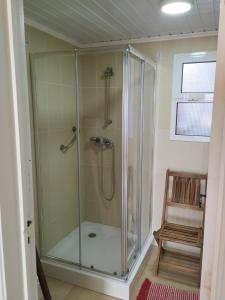 a shower with a glass door in a bathroom at Sea U in Lagoa