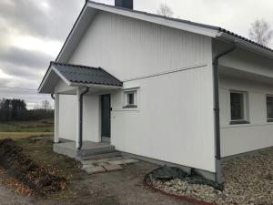 a white house with a black roof at Practical Studio for 2 in Vöyri
