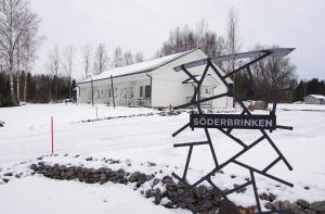 a sign in the snow in front of a building at Practical Studio for 2 in Vöyri
