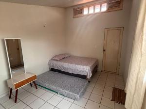 a room with two beds and a mirror in it at JGM chalés in Barreirinhas