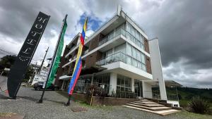 a building with flags in front of it at LUXURY Hotel in Santa Rosa de Cabal