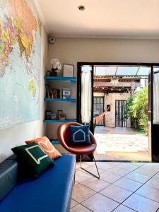a living room with a blue couch and a chair at Lulle Hostel - Congonhas - Expo - Interlagos - Morumbi in São Paulo