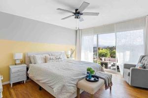 a bedroom with a bed and a ceiling fan at Coastal Farmhouse with Views in Spring Valley