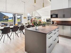 a kitchen and dining room with a table and chairs at 5 star holiday home in Sydals in Sarup