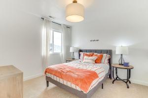 a bedroom with a bed with orange pillows and a window at 4 Mi to Zions Bank Stadium Sleek Herriman Retreat in Herriman