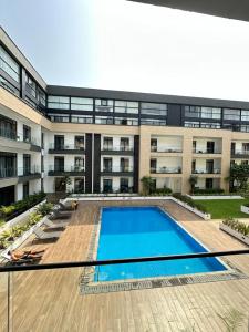 an empty swimming pool in front of a building at Cozy Abode by Embassy Gardens in Cantonments