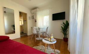 a living room with a bed and a table and a dining room at Apartment Dubrovnik in Dubrovnik