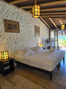 a bedroom with a large bed in a room at Las Cabañas de Antica in Vichayito +62 photos