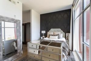 a bedroom with a bed and a mirror at 5M307- Elegant Condo with Rooftop Deck in Nashville