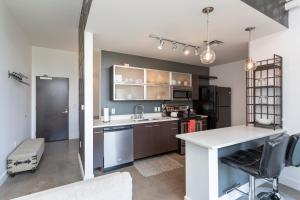 a kitchen with a sink and a counter top at 5M307- Elegant Condo with Rooftop Deck in Nashville