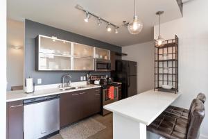 a kitchen with a sink and a counter top at 5M307- Elegant Condo with Rooftop Deck in Nashville