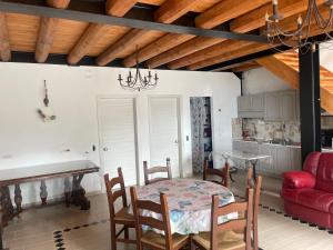 a dining room with a table and a red couch at TENUTA BORGATO MORELLI in Este
