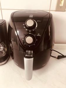 a black toaster sitting on top of a counter at Apartamento Caminho da Praia in Parnaíba +7 photos