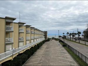 einen Fußweg neben einer Reihe von Apartmentgebäuden in der Unterkunft Ocean Views steps to beach - Shoreline Stays 29 in Galveston