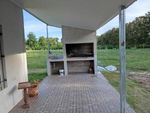 a screened in patio with a television and a fireplace at Mukanga in San Pedro