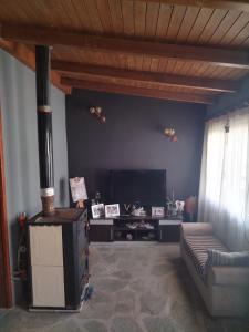 a living room with a couch and a fireplace at J&F village house in Arta