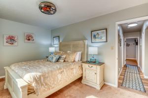 a bedroom with a king sized bed and a night stand at The Pacific Lookout Sleeps 6, Hot Tub, Pet Friendly, Ocean View, EV Charger in Salishan Beach
