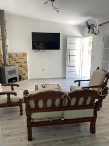 una sala de estar con un sofá y dos sillas en Abdulle Complejo Turistico Centro, en Villa Cura Brochero