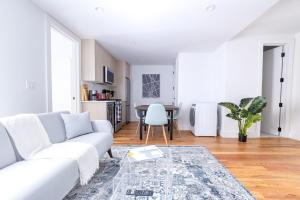 a white living room with a white couch and a table at 323-2 Spacious 2BR Williamsburg in Brooklyn