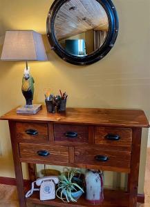 a wooden dresser with a lamp and a mirror at Sqc Downtown Retreat in Sequim +35 photos