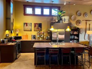 a kitchen with a large island with bar stools at Sqc Downtown Retreat in Sequim