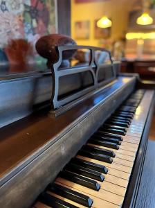 a close up of a piano keyboard with a woodenvation at Sqc Downtown Retreat in Sequim