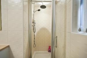 a shower with a glass door in a bathroom at HILLTOP PLACE SUITES 4 Bedrooms near PEAK DISTRICT in Killamarsh +41 photos