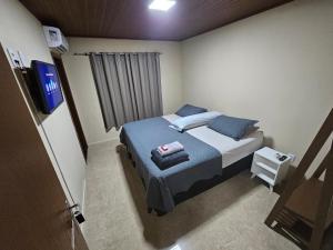 Postel nebo postele na pokoji v ubytování Hospedagem Costa BNU - Família