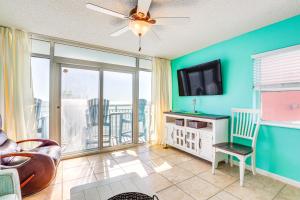 a living room with a couch and a tv at Walk to SkyWheel Oceanfront Myrtle Beach Condo! in Myrtle Beach