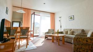 a living room with a couch and a table at Pension Kueck in Büsum