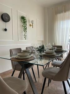 a dining room with a glass table and chairs at 'Il Duomo' nel centro di Frascati in Frascati