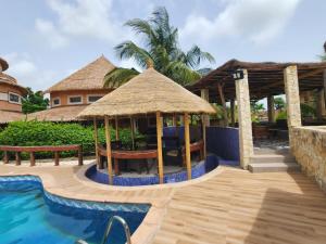 a resort with a gazebo and a swimming pool at Résidence Tina 1 in Ngalou Sessène