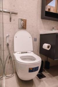 a bathroom with a white toilet and a shower at Soraya Abelempkpe in Accra