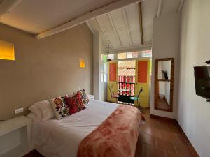 a bedroom with a large bed with pillows on it at La Puerta - Pueblito Boyacense in Duitama