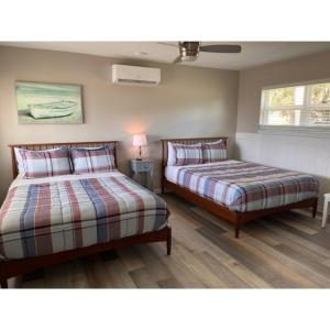 a bedroom with two beds and a lamp in it at Crescent Fish Camp, RV Resort & Marina in Crescent City +32 photos