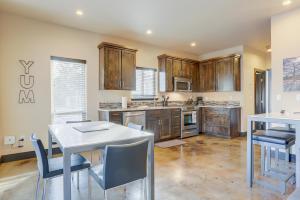 a kitchen with wooden cabinets and a white table and chairs at Urban Roundabout in Bend