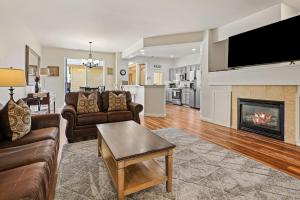 a living room with two couches and a fireplace at Old Mill Magic in Bend