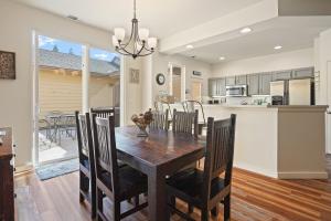 a kitchen and dining room with a wooden table and chairs at Old Mill Magic in Bend